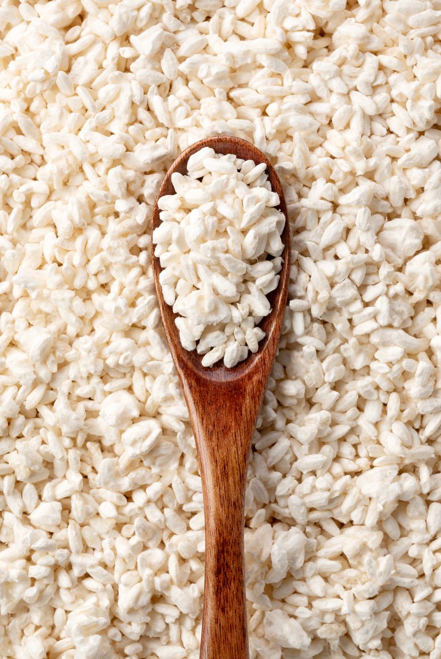 Close-up of rice koji and wooden spoon.